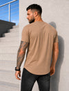 Back view of men’s beige SAINTS T-shirt with asymmetric hem and premium casual fit