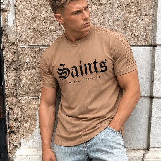 Men’s beige graphic tee with ribbed shoulder details, asymmetric hem, and premium casual styling