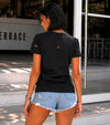 Women’s black cotton T-shirt with red graphic print, distressed cutouts, and casual summer outfit look