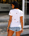 Women’s white cotton T-shirt with red graphic print, distressed cutouts, and relaxed everyday fit