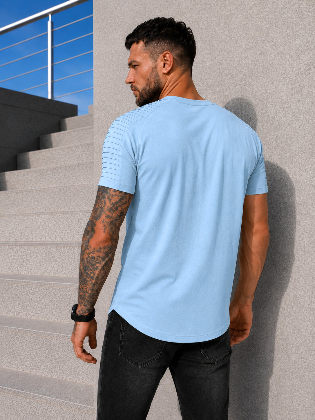 Back view of men’s light blue KRUTYAKOV T-shirt with asymmetric hem and premium casual fit
