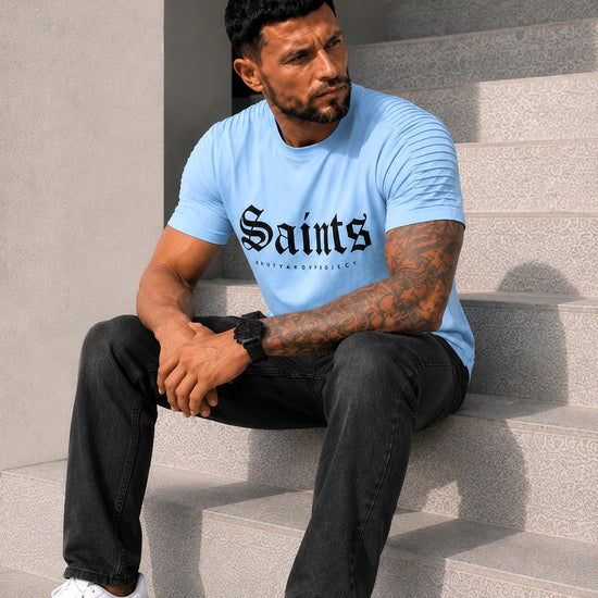 KRUTYAKOV men’s light blue graphic tee styled with black pants for a clean urban casual outfit
