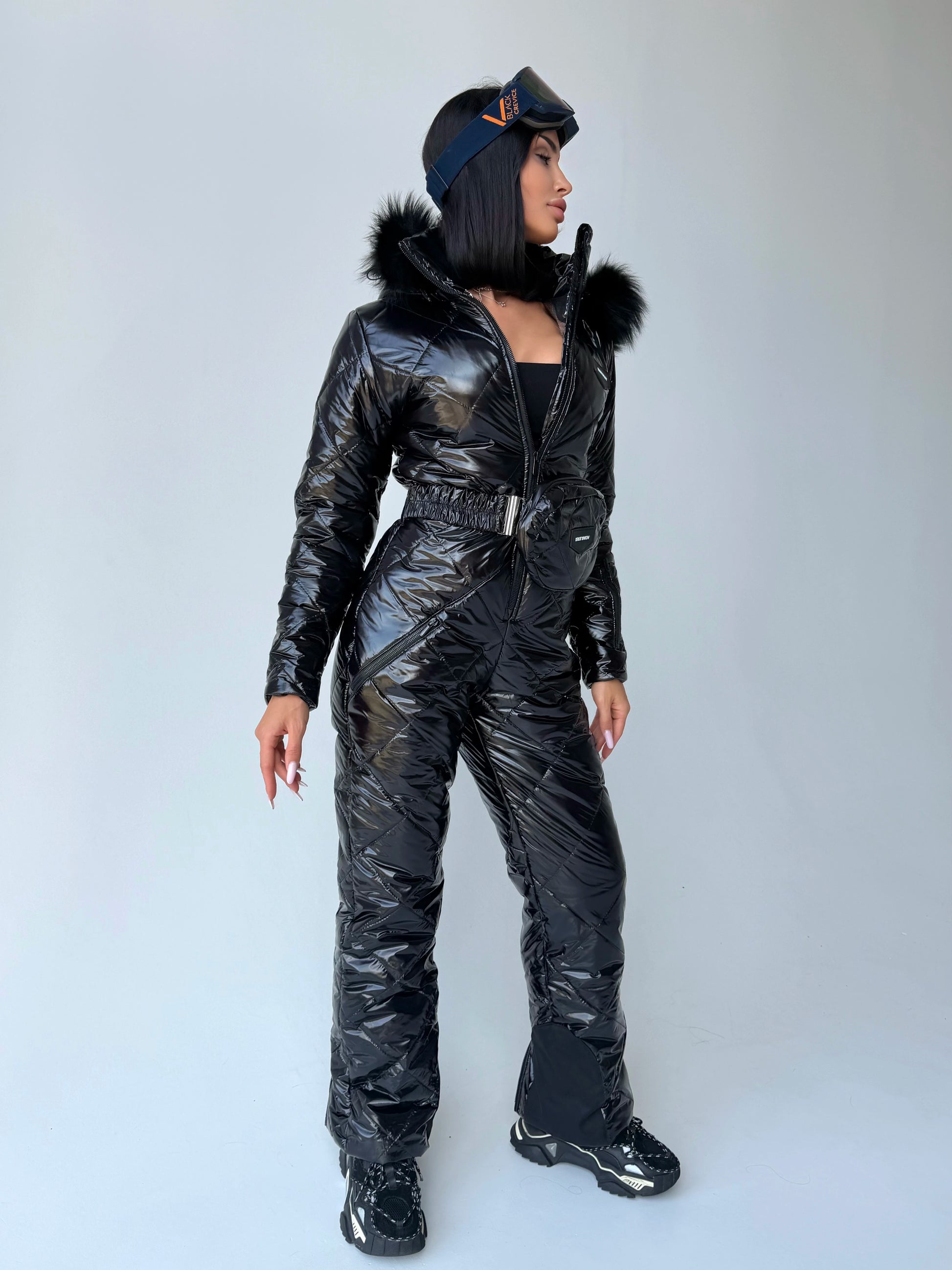 Women’s black glossy winter ski jumpsuit with fur-trimmed hood