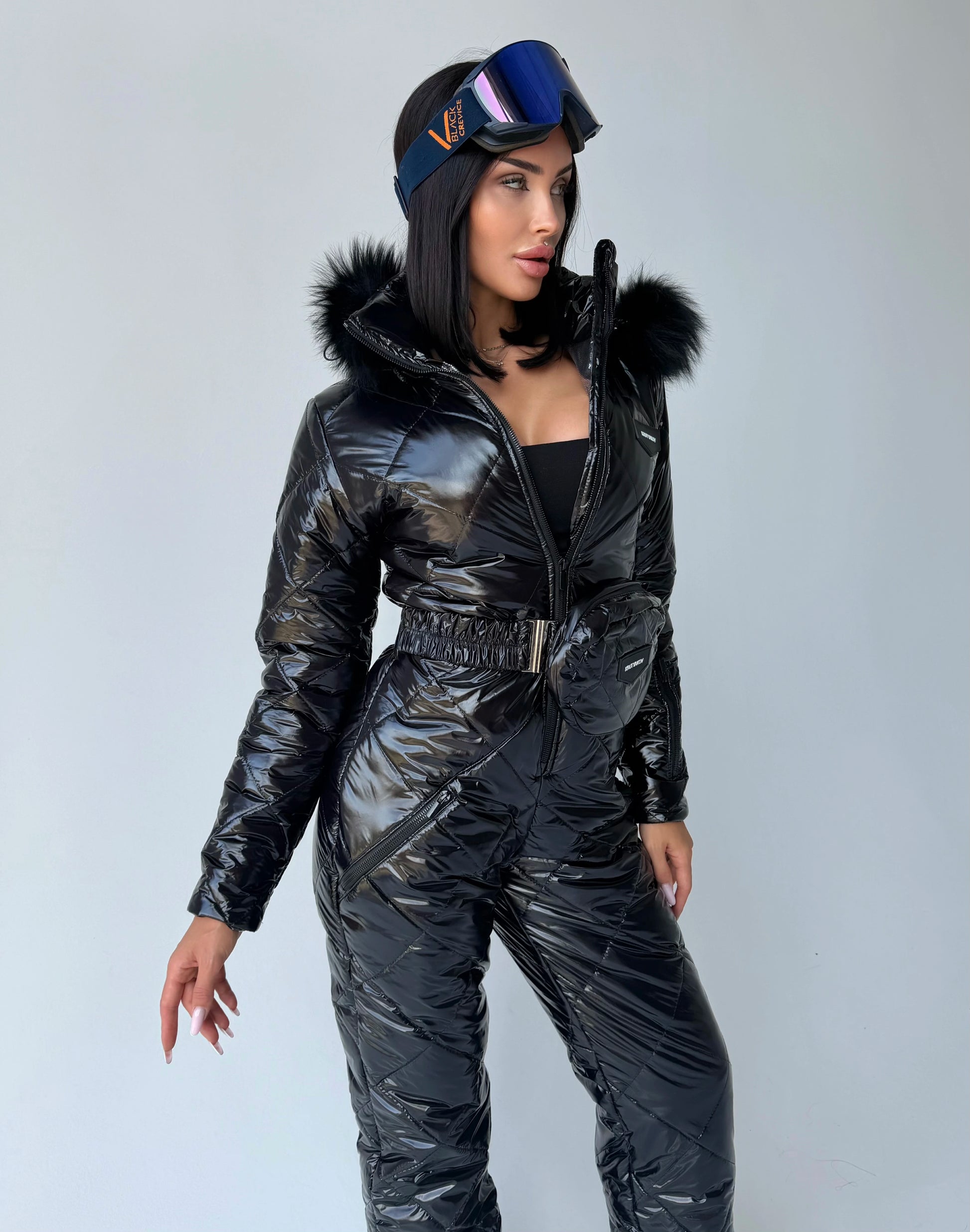 Designer black glossy one piece snow suit for women by KRUTYAKOV