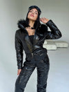 Women’s black glossy ski suit with detachable fur-trimmed hood