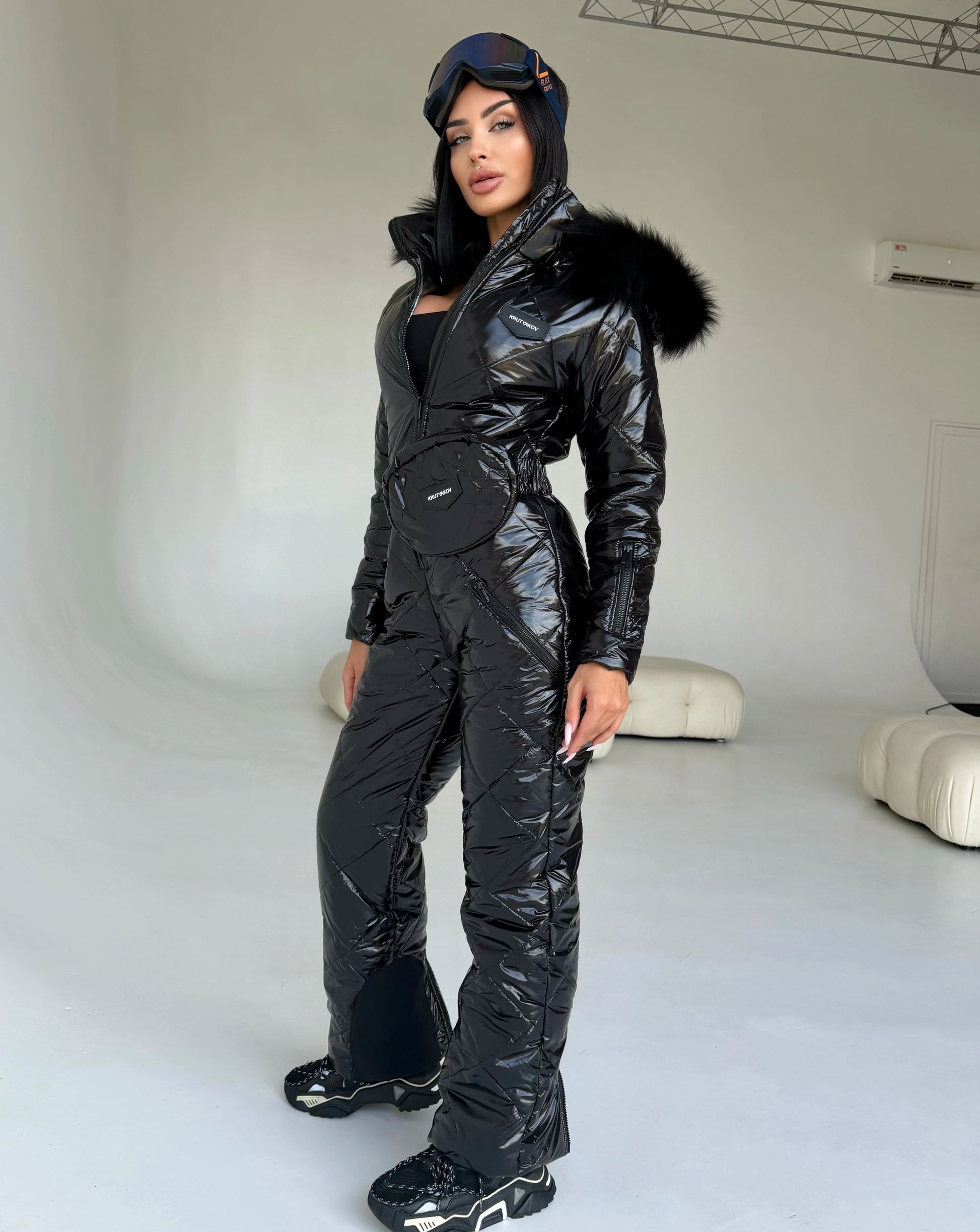KRUTYAKOV women’s black glossy ski suit with zippered front and fur hood