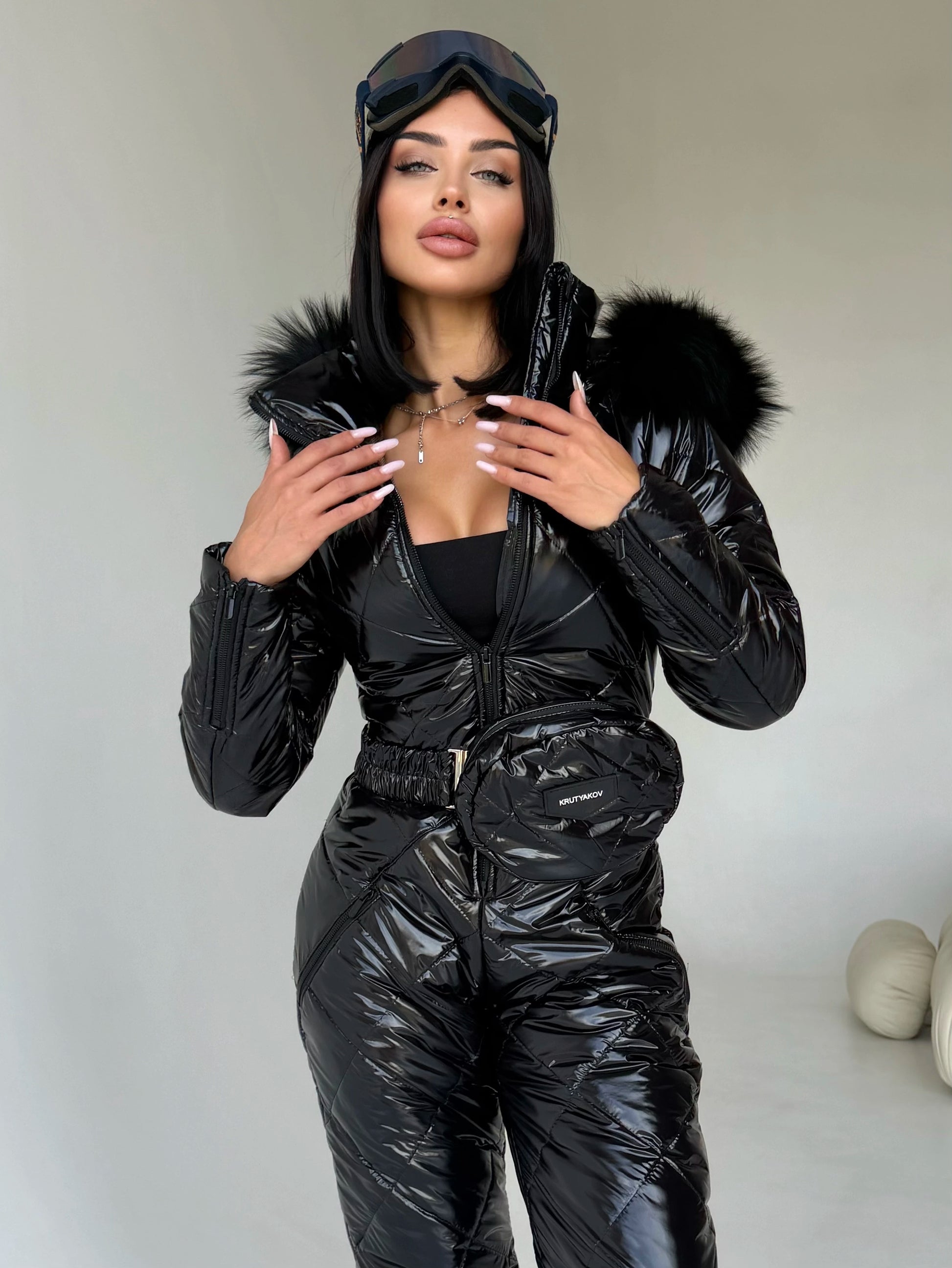 Women’s black glossy ski suit with detachable fur-trimmed hood