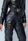 Black glossy ski suit detail with adjustable waist belt and zip pockets