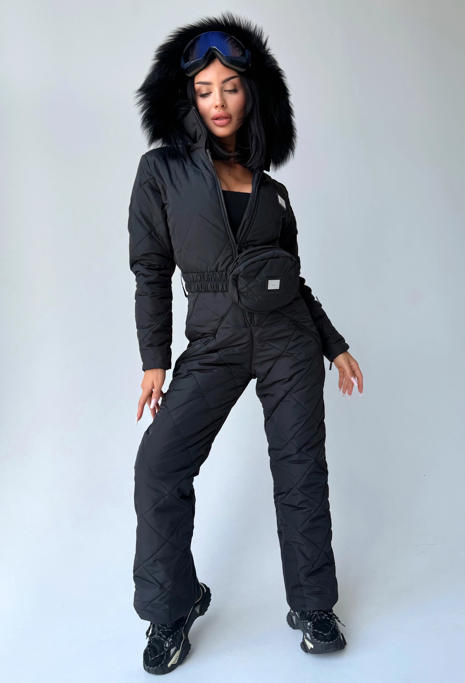 Women’s black winter ski jumpsuit with fitted waist and fur hood