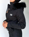 Women’s black ski suit detail with functional pockets and winter insulation
