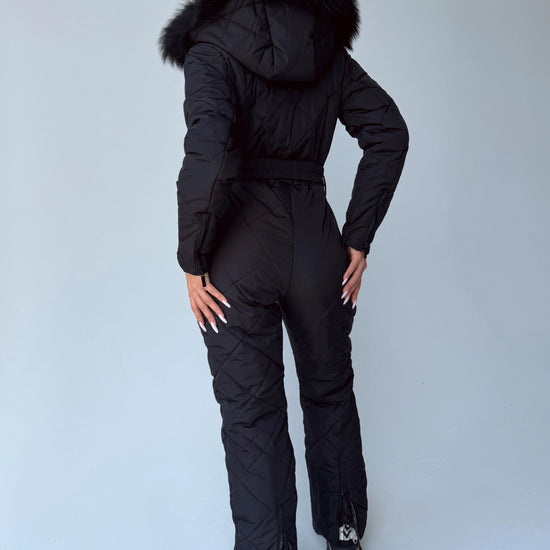Back view of women’s black matte insulated one piece ski suit