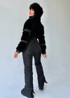 Side view of women’s black winter jumpsuit with eco fur by KRUTYAKOV
