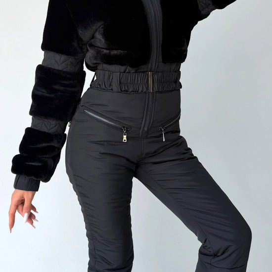 Black winter jumpsuit detail with fitted waist and insulated pants