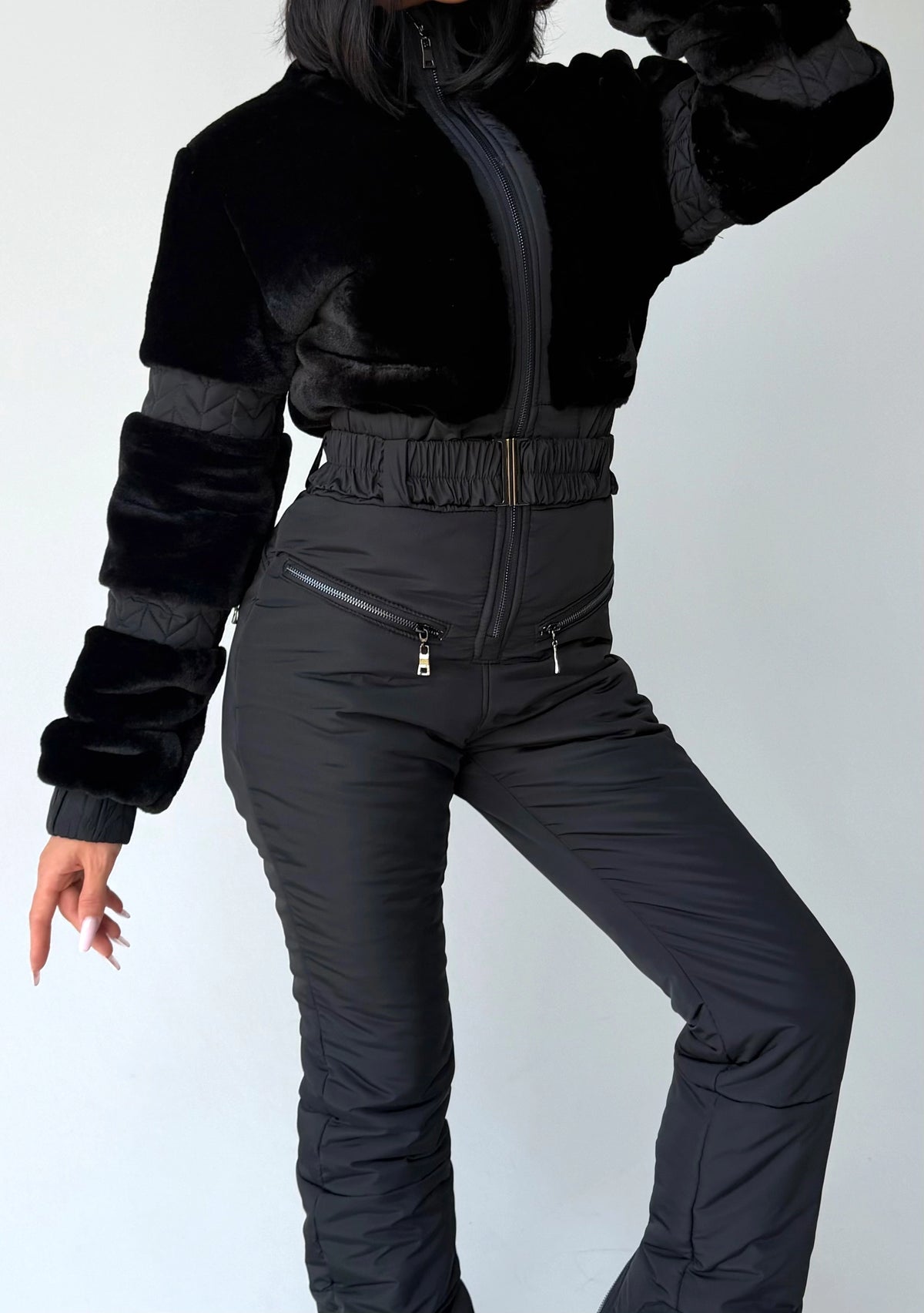 Black winter jumpsuit detail with fitted waist and insulated pants
