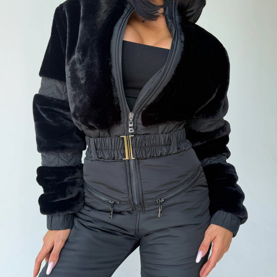 Women’s black insulated winter jumpsuit with eco fur trim and fitted waist