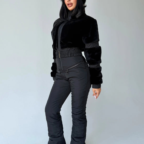 Women’s black winter jumpsuit full-body view with matching mittens