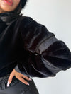 Black winter jumpsuit detail with eco fur texture and front zipper
