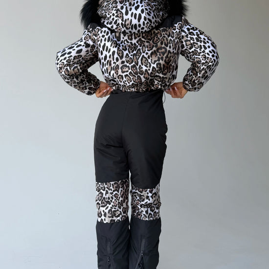 Front view of women’s leopard ski suit with fur-trimmed jacket