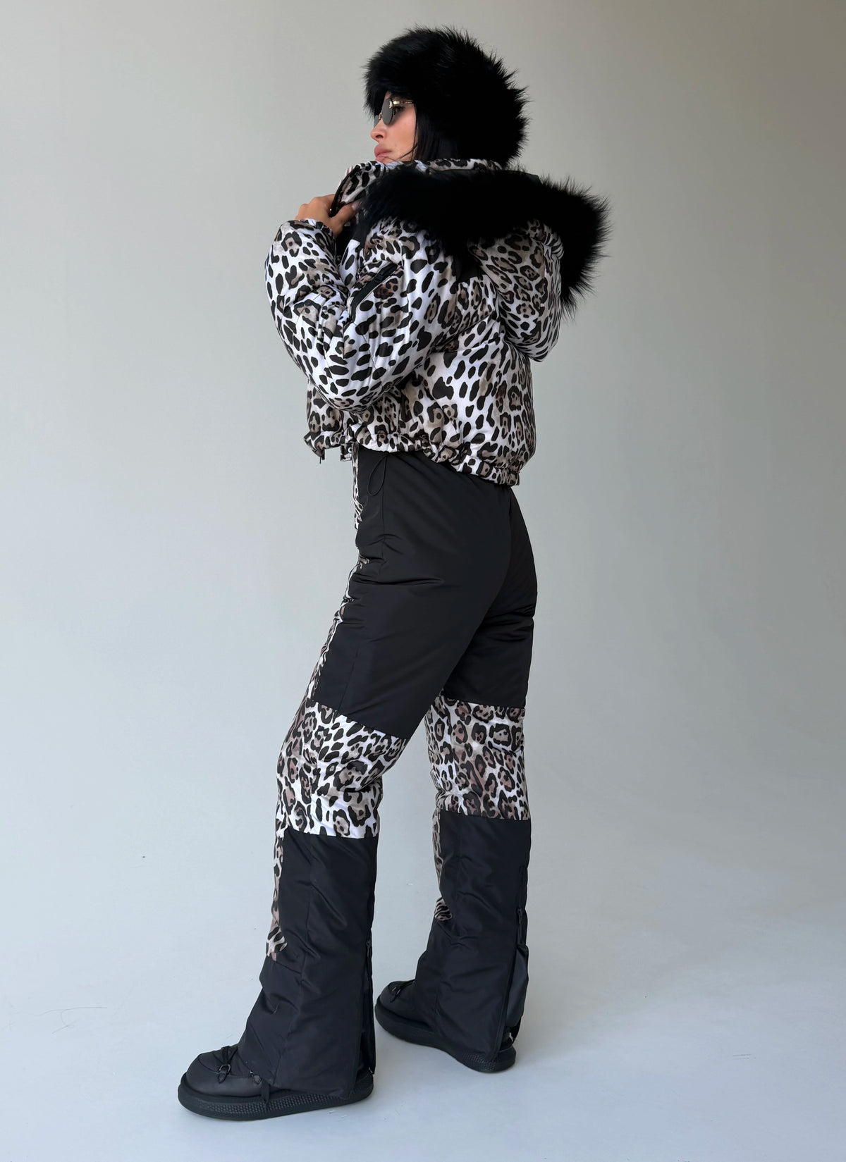Rear view of women’s leopard two-piece snowsuit by KRUTYAKOV