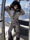 Designer women’s leopard ski outfit with black fur hood in the Alps