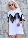 Side view of KRUTYAKOV oversized white T-shirt showing long fringe detail and loose comfortable shape