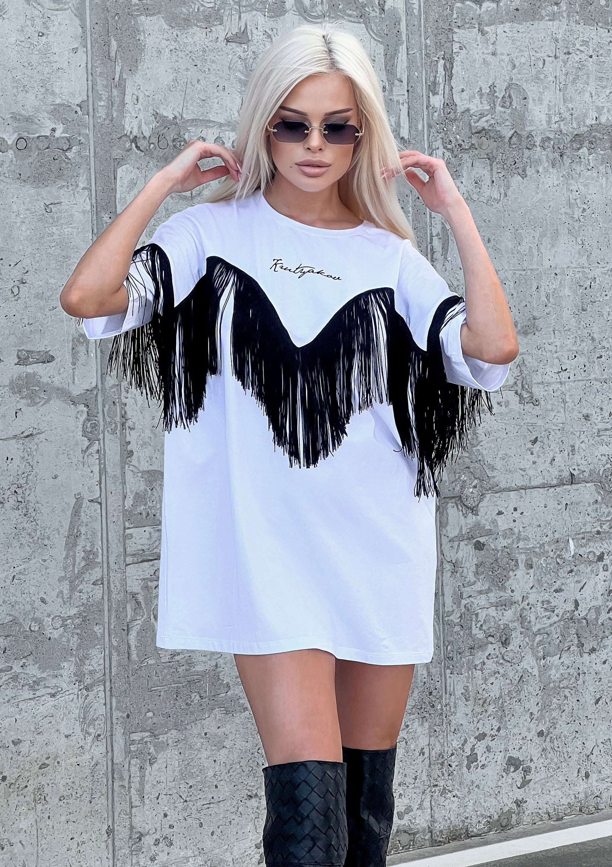 Front view of Ankora white fringe T-shirt styled as an everyday streetwear outfit with sunglasses and relaxed fit