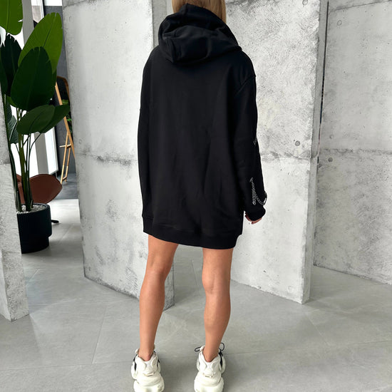 Oversized women’s black hoodie with front zipper and metal accents