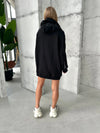Oversized women’s black hoodie with front zipper and metal accents