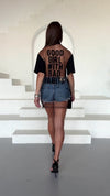 Back view of KRUTYAKOV black T-shirt showing sheer mesh panel and statement graphic print
