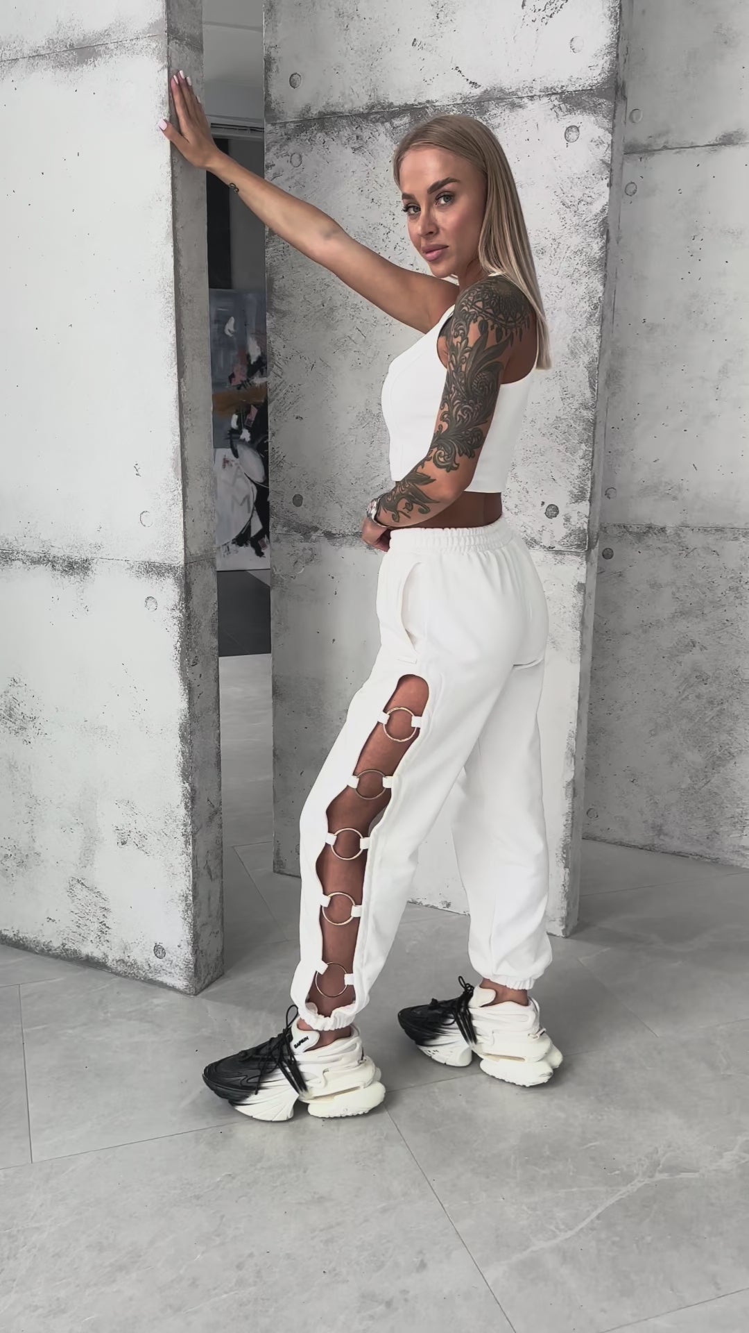 KRUTYAKOV white high-waist joggers styled with crop top for streetwear look