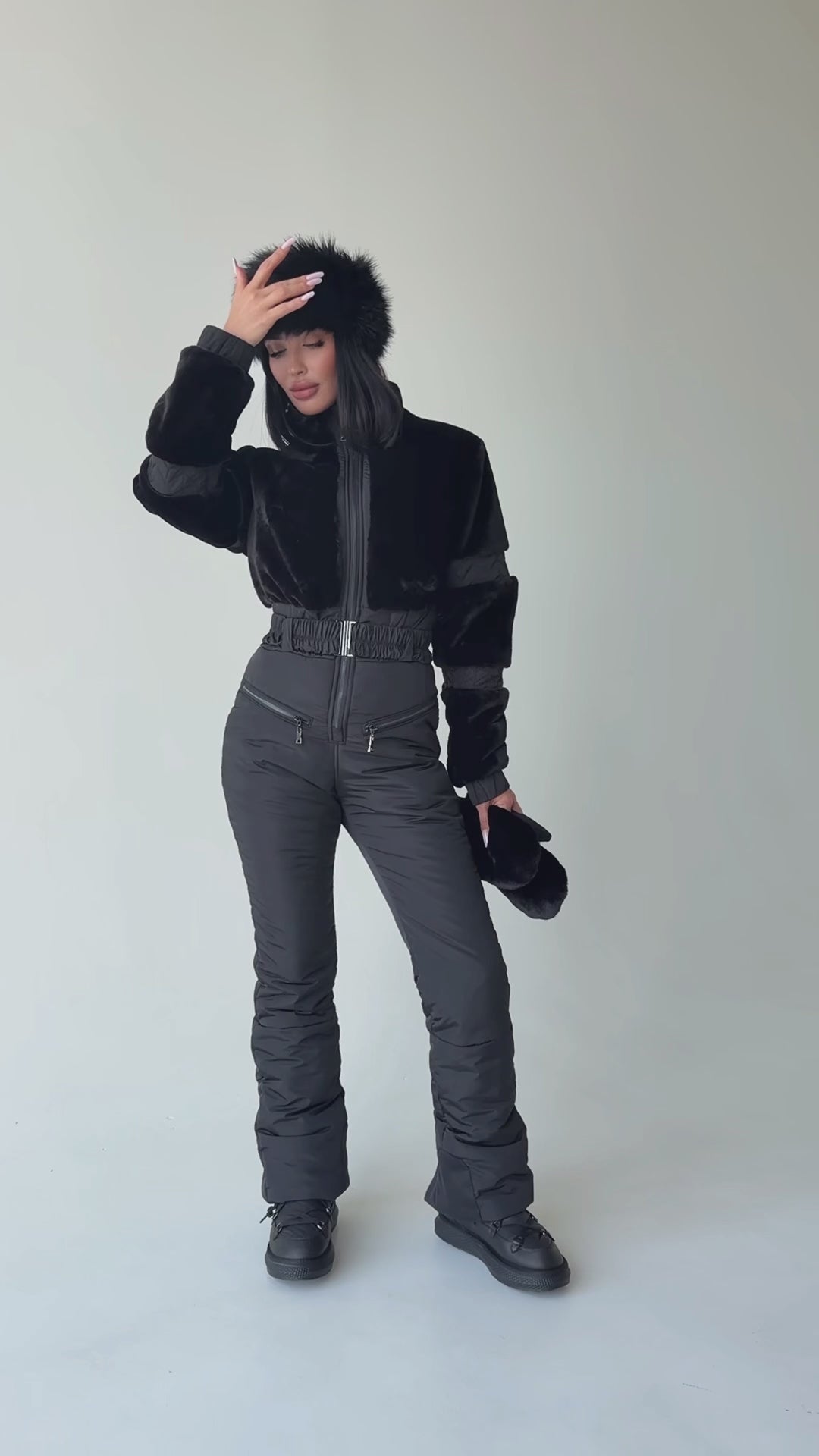 Full-length view of KRUTYAKOV women’s black winter jumpsuit with eco fur