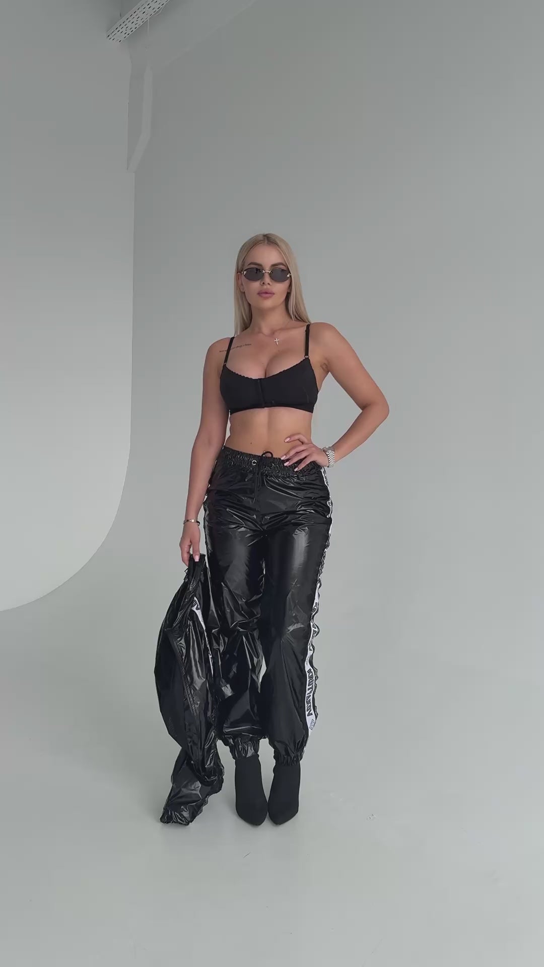 KRUTYAKOV women’s black statement tracksuit set with glossy finish, cropped jacket, and confident urban look
