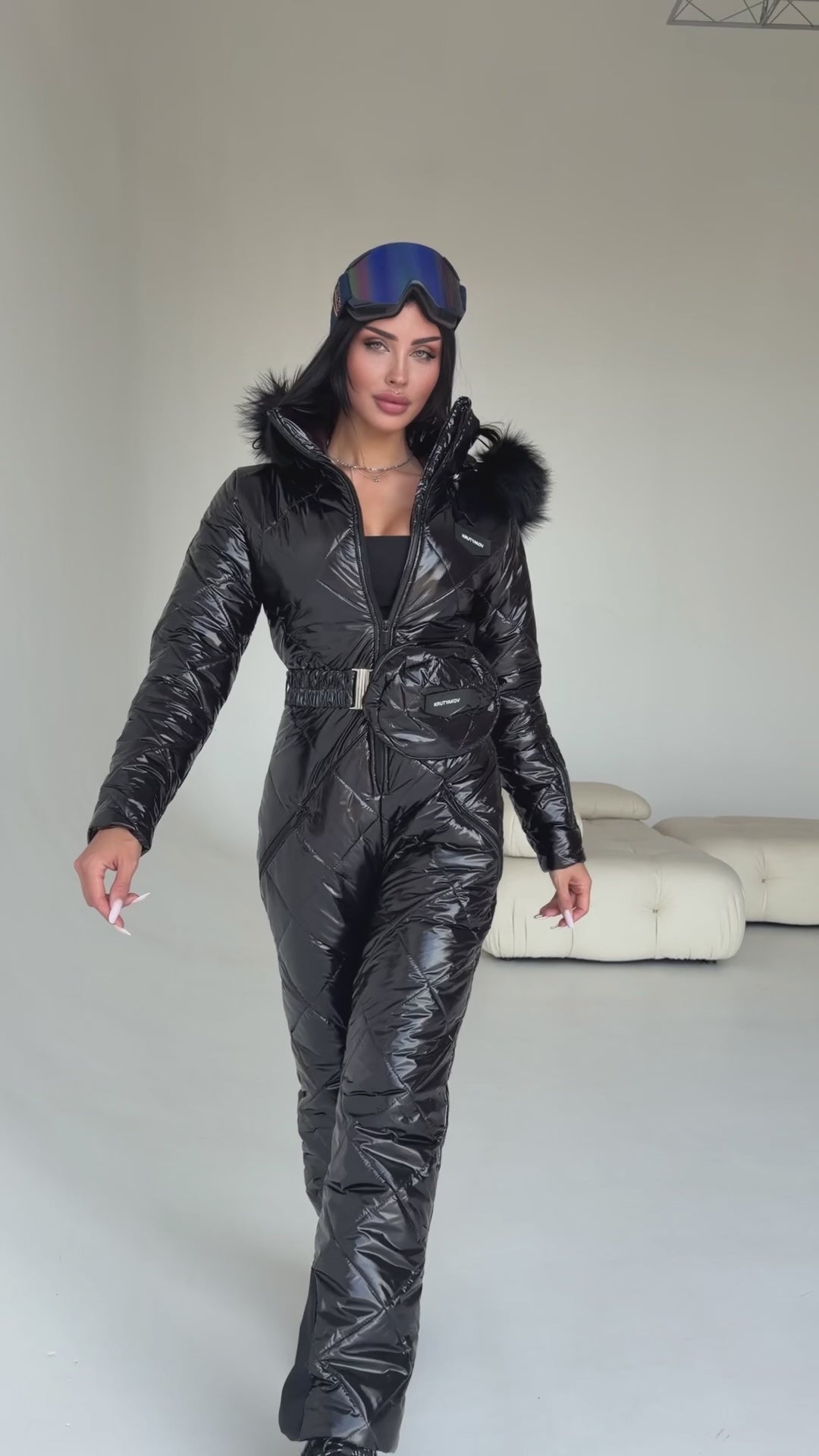 Women wearing KRUTYAKOV black glossy one piece ski suit