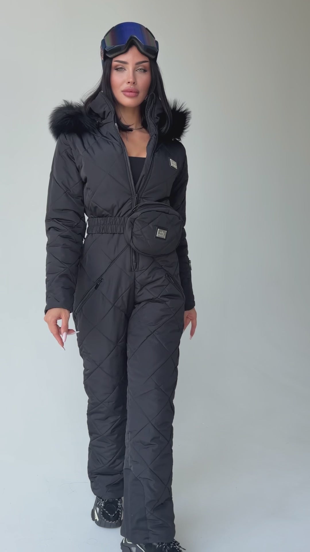 Women wearing KRUTYAKOV black matte one piece ski suit