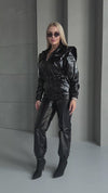 KRUTYAKOV black glossy jumpsuit side view with sleek fitted silhouette