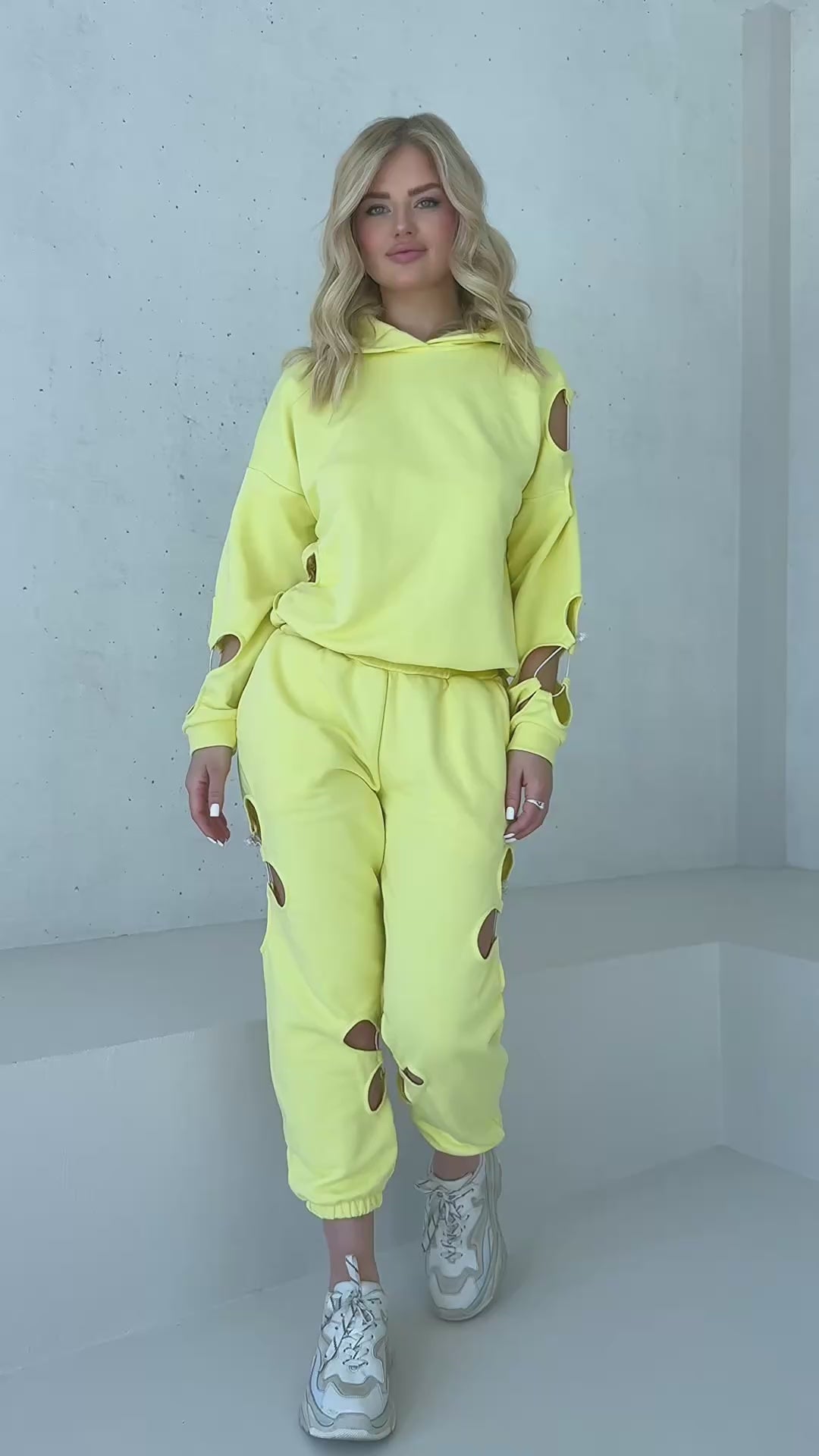 Yellow women’s two piece sweatsuit with hoodie and joggers designed for travel outfits and casual city looks