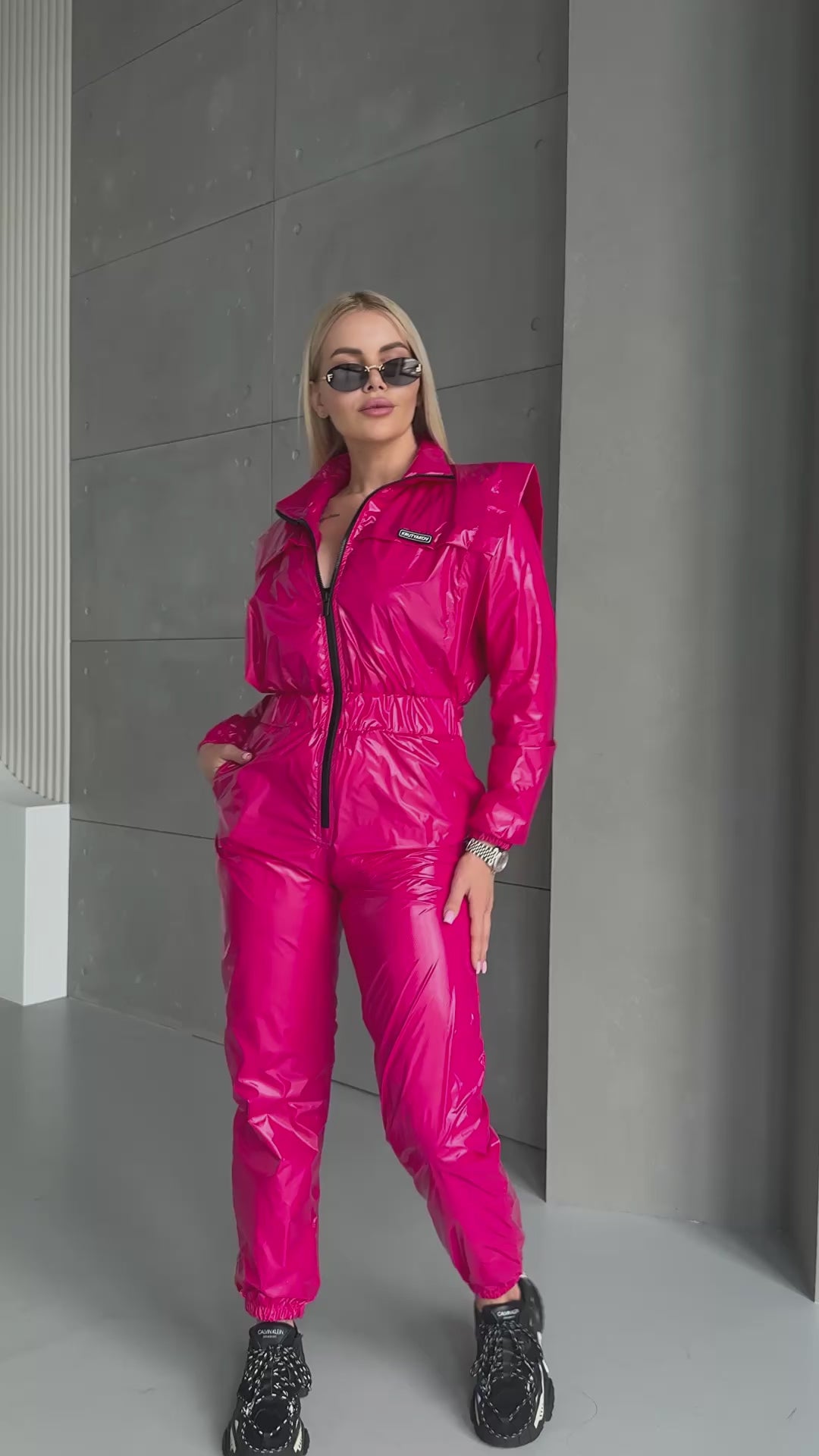 KRUTYAKOV pink glossy one-piece jumpsuit styled for party and streetwear looks