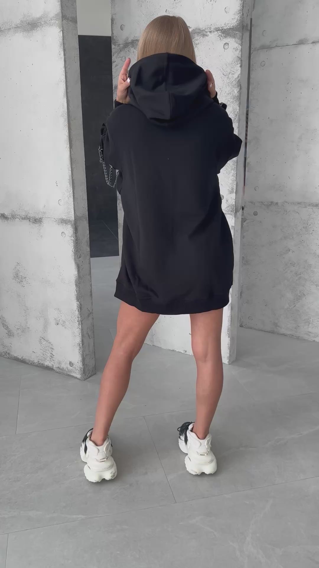 Designer black hoodie with chain details for concerts and city looks